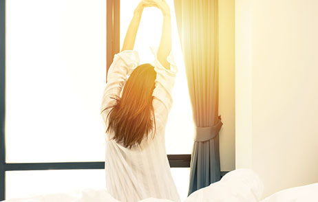 Ein Frau ist aufgewacht und streckt sich